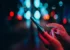 Woman's hands using smartphone in city street at night.