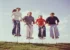 Friends jumping on pogo sticks